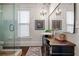 Bathroom with glass-enclosed shower, chandelier lighting and wooden vanity at 513 Saint Charles Ne Ave, Atlanta, GA 30308