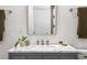 Bathroom featuring marble countertop, decorative faucet, and framed mirror at 513 Saint Charles Ne Ave, Atlanta, GA 30308