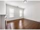 Bright bedroom with hardwood floors, fireplace, and natural light from two windows at 513 Saint Charles Ne Ave, Atlanta, GA 30308