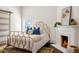 Bright bedroom featuring a decorative fireplace, gold bed frame, and stylish accents at 513 Saint Charles Ne Ave, Atlanta, GA 30308