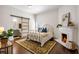 Primary bedroom with a decorative fireplace and a sliding door leading to the bathroom at 513 Saint Charles Ne Ave, Atlanta, GA 30308