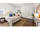 Spacious bedroom with a gold bed frame, stylish rug, and a decorative fireplace at 513 Saint Charles Ne Ave, Atlanta, GA 30308