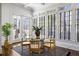 Bright dining area featuring large windows, hardwood floors, and a modern glass-top table at 513 Saint Charles Ne Ave, Atlanta, GA 30308