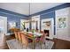 Dining room with blue walls, hardwood floors, fireplace, and seating for six at 513 Saint Charles Ne Ave, Atlanta, GA 30308