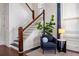 Staircase with wood railing and trim detail, paired with stylish decor, creates an inviting entry space at 513 Saint Charles Ne Ave, Atlanta, GA 30308