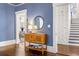 Elegant entryway with hardwood floors, blue walls, decorative wood table, and stairway at 513 Saint Charles Ne Ave, Atlanta, GA 30308