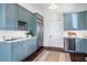 Modern kitchen featuring blue cabinets, stainless steel refrigerator, and bright countertops at 513 Saint Charles Ne Ave, Atlanta, GA 30308