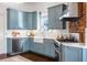 Beautiful kitchen features blue custom cabinets, stainless steel appliances, and apron-front sink at 513 Saint Charles Ne Ave, Atlanta, GA 30308