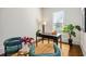 Well-lit office space with dark desk, green chairs, and a jute rug at 513 Saint Charles Ne Ave, Atlanta, GA 30308