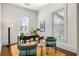 Office with two large windows, a dark wood desk, and decorative green accent chairs at 513 Saint Charles Ne Ave, Atlanta, GA 30308