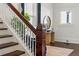 Elegant staircase with dark wood railings and white spindles, complemented by stylish decor and artwork at 513 Saint Charles Ne Ave, Atlanta, GA 30308