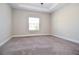 Spacious bedroom featuring plush carpeting, ceiling fan, and natural light from a window at 223 Villa Park Cir, Stone Mountain, GA 30087