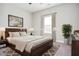 Well-lit bedroom featuring neutral walls and window with plant and decor at 223 Villa Park Cir, Stone Mountain, GA 30087