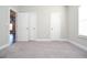 Carpeted bedroom featuring multiple closets and neutral walls at 223 Villa Park Cir, Stone Mountain, GA 30087