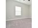 Bright bedroom with a window offering natural light and neutral carpet at 223 Villa Park Cir, Stone Mountain, GA 30087