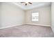 Spacious bedroom featuring plush carpeting, ceiling fan, and natural light from a window at 223 Villa Park Cir, Stone Mountain, GA 30087