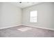 Bright bedroom with a window offering natural light and neutral carpet at 223 Villa Park Cir, Stone Mountain, GA 30087