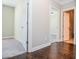 Hardwood hallway connecting to carpeted bedrooms and bathrooms and closets at 223 Villa Park Cir, Stone Mountain, GA 30087