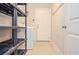 Laundry room with tile floor, door, shelving, and a washing machine at 223 Villa Park Cir, Stone Mountain, GA 30087