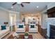 Staged living room showcasing open floor plan with modern kitchen and fireplace at 223 Villa Park Cir, Stone Mountain, GA 30087