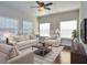 Staged living room with large windows, hardwood floors, and comfortable seating at 223 Villa Park Cir, Stone Mountain, GA 30087