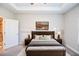 Staged main bedroom with tray ceiling and adjoining bathroom at 223 Villa Park Cir, Stone Mountain, GA 30087