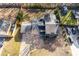 Aerial view of a fenced-in backyard, garage, and driveway with multiple vehicles at 2412 Renny Ct, Marietta, GA 30066