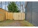 New back gate with iron hardware and a view of the neighboring house at 2412 Renny Ct, Marietta, GA 30066