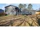 Backyard view showing a gray two-story home, deck, and spacious lawn at 2412 Renny Ct, Marietta, GA 30066