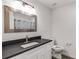 Bathroom with sleek vanity, stone countertop, modern fixtures, and framed mirror above the sink at 2412 Renny Ct, Marietta, GA 30066