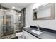 Bathroom features a stone tiled shower, modern vanity, and a framed mirror at 2412 Renny Ct, Marietta, GA 30066