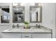 Modern bathroom with double vanity, granite countertop, framed mirrors, and updated fixtures at 2412 Renny Ct, Marietta, GA 30066