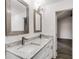 Bright bathroom with a double sink vanity, granite countertop, and framed mirrors at 2412 Renny Ct, Marietta, GA 30066