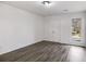 Clean bedroom featuring wood-look floors, a window for natural light, and a double door closet at 2412 Renny Ct, Marietta, GA 30066