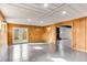 Wood-paneled bonus room with french doors, tiled floor, and access to the living area at 2412 Renny Ct, Marietta, GA 30066