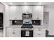 Bright kitchen with white cabinetry, stainless steel appliances, and contemporary finishes at 2412 Renny Ct, Marietta, GA 30066