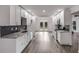 Well-lit kitchen featuring white cabinets, stainless steel appliances, and herringbone backsplash at 2412 Renny Ct, Marietta, GA 30066