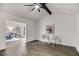 Open living room with grey wood-look flooring, vaulted ceiling, ceiling fan, and stylish decor at 2412 Renny Ct, Marietta, GA 30066