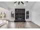 Cozy living room featuring a stone fireplace, two windows, and access to the backyard at 2412 Renny Ct, Marietta, GA 30066