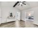 Open living room featuring grey wood-look flooring, white walls, a vaulted ceiling, and lots of natural light at 2412 Renny Ct, Marietta, GA 30066