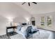 Bright main bedroom featuring a vaulted ceiling, large windows, ceiling fan, and grey wood-look flooring at 2412 Renny Ct, Marietta, GA 30066