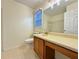 Bathroom featuring wood cabinet vanity, large mirror, and tile flooring at 3533 Mulberry Way, Duluth, GA 30096