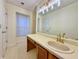 Bright bathroom featuring a vanity with a large mirror and ample counter space and a large window at 3533 Mulberry Way, Duluth, GA 30096