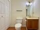 Half bathroom featuring wood cabinet vanity, mirror, and tile flooring at 3533 Mulberry Way, Duluth, GA 30096