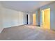 An empty bedroom featuring carpet flooring and two doorways at 3533 Mulberry Way, Duluth, GA 30096