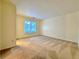 An empty bedroom featuring carpet flooring and a window at 3533 Mulberry Way, Duluth, GA 30096