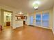 Open dining area with a view of the kitchen, wood-look flooring, and natural light at 3533 Mulberry Way, Duluth, GA 30096