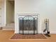 Close-up of the fireplace with decorative screen and brick hearth at 3533 Mulberry Way, Duluth, GA 30096