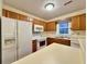 Cozy kitchen features white appliances and wood cabinetry at 3533 Mulberry Way, Duluth, GA 30096