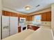 Traditional kitchen with white appliances, wood cabinets and plenty of light at 3533 Mulberry Way, Duluth, GA 30096